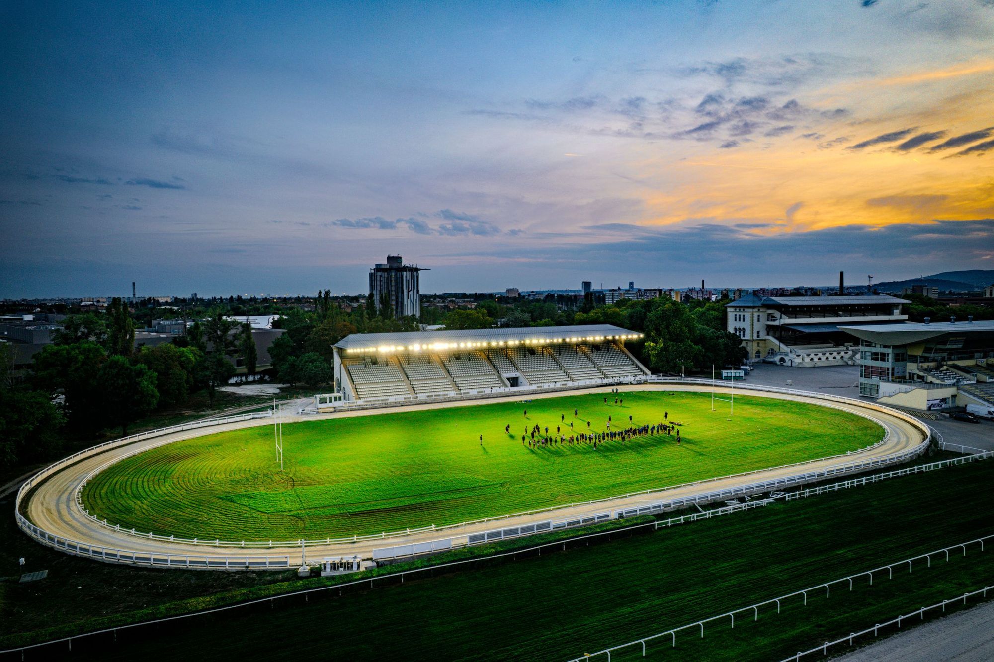 Aerial view of an illuminated horse racing track in Budapest at sunset
