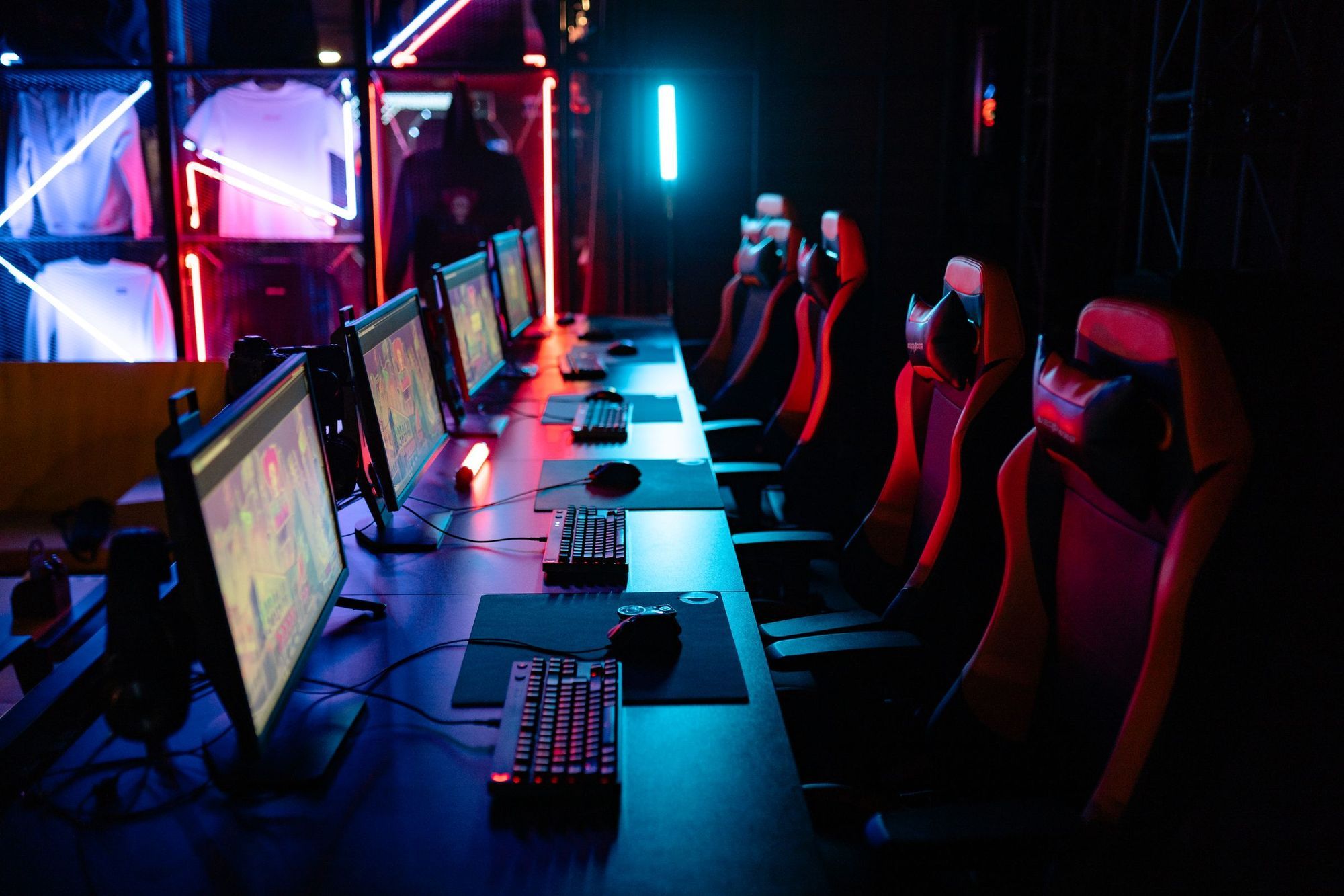 Rows of gaming PCs, monitors and chairs in an esports gaming house